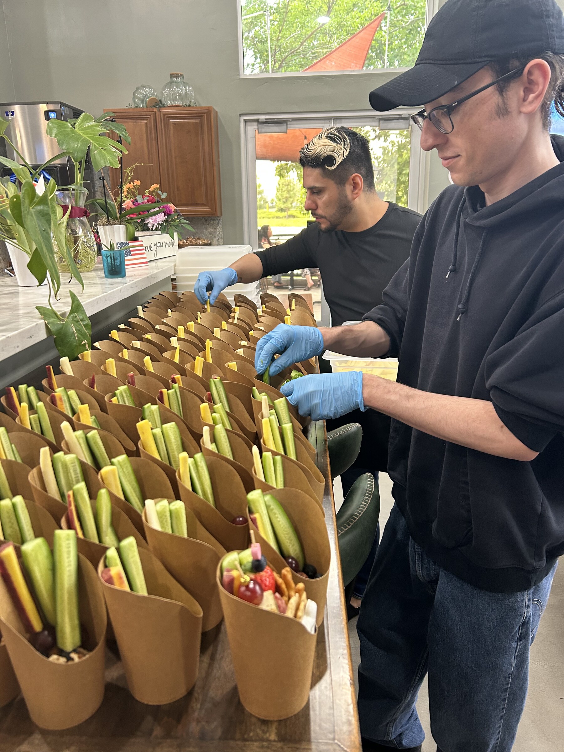 CharQterie team preparing rows of individual fresh catering cups